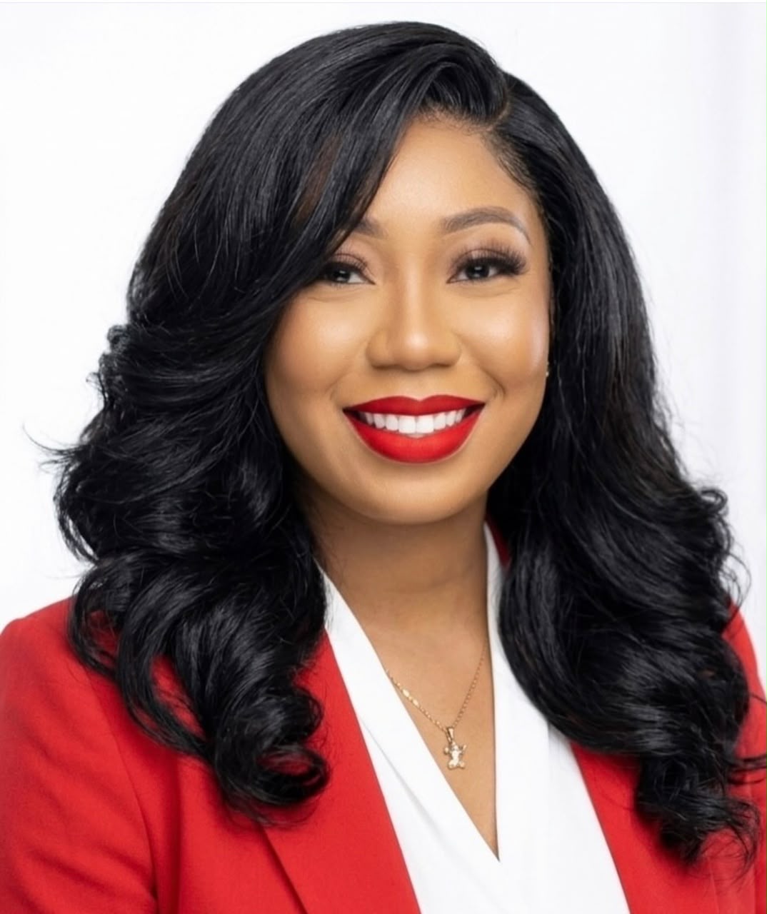 Ekpenyong Boluwatife smiling in a red blazer and white blouse